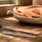 An emery board next to a nail file on a white background.