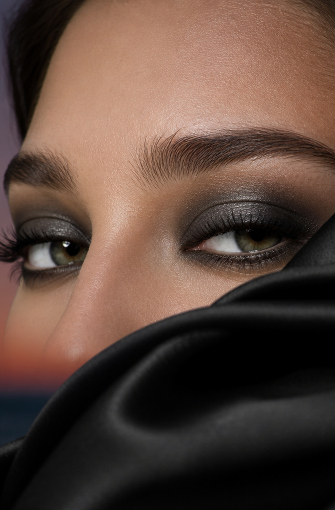 20 Black Makeup Looks for Every Mood and Moment 17 A close-up of a model's eyes with a smoky makeup look.